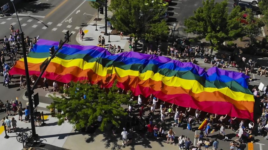 Supporters parade a giant rainbow flag through Downtown Boise during the annual Boise Pride Fest Parade Saturday, June 15, 2019.