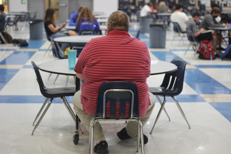 Mr. Haines sits in the cafeteria, subbing during a 4th period class.