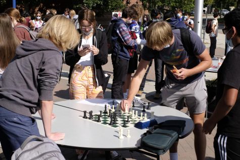 Students at club rush gather around the chess clubs table.
