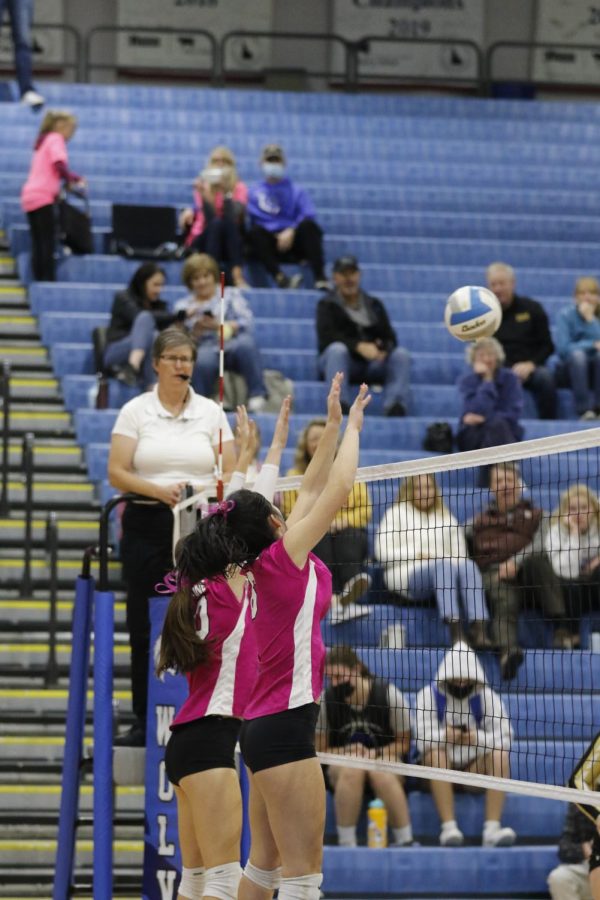 Ella Apple (senior, right) and Whitleigh Walsh (freshman, left) jump up to block the ball.