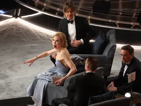 Nicole Kidman dramatically reacts to something on the Oscars stage.