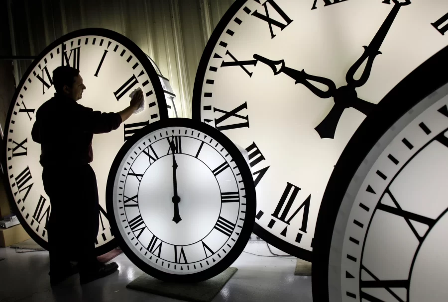 A horologist in New Jersey cleans clocks before adding an hour to account for daylight savings time.