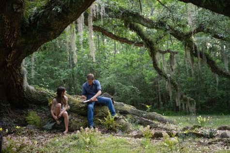 A Vanity Fair First Look shows Daisy Edgar-Jones as Kya and Taylor John Smith as Tate Walker in the movie adaptation of Where the Crawdads Sing. 