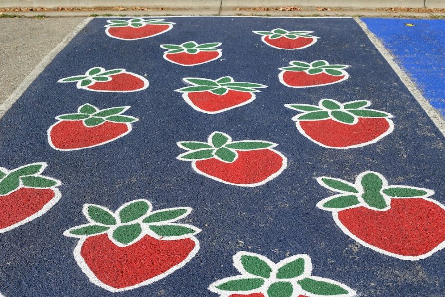 12. A cute parking spot design that includes a multitude of strawberries. 