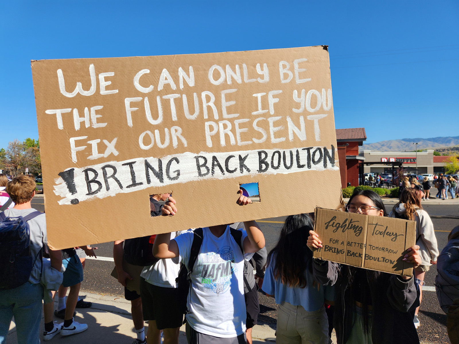 Timberline students hold signs while protesting teacher Laura Boultons suspension.