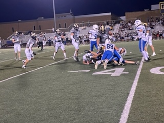 The Varsity team makes a tackle in the game against Meridian. 