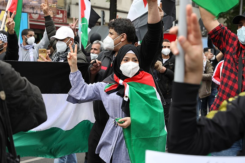 A woman protests for peace between Israel and Palestine at a rally in Germany. 