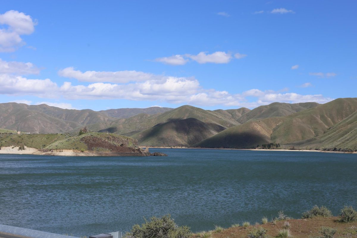 A photo taken at the top of the Lucky Peak Dam Road that presents the beautiful lake and foothills. 
