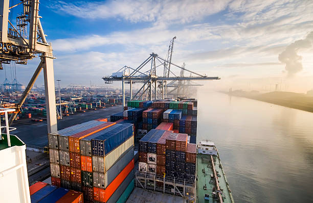 Sunrise in busy container terminal in Rotterdam, Netherlands.