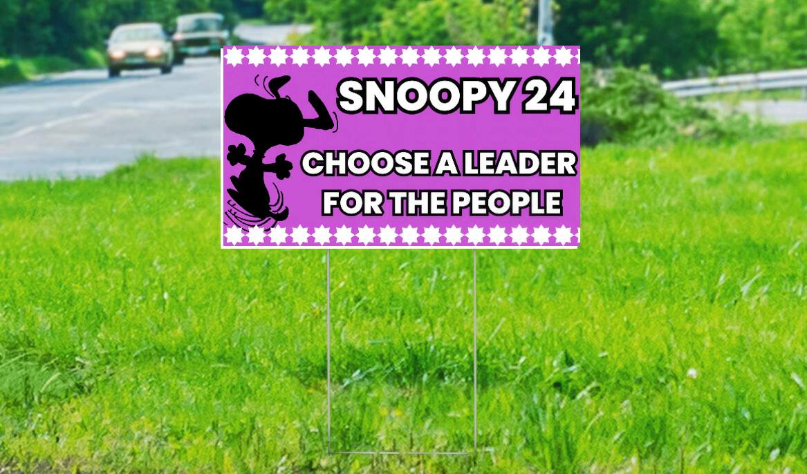 A yard sign displaying support for Snoopy. 