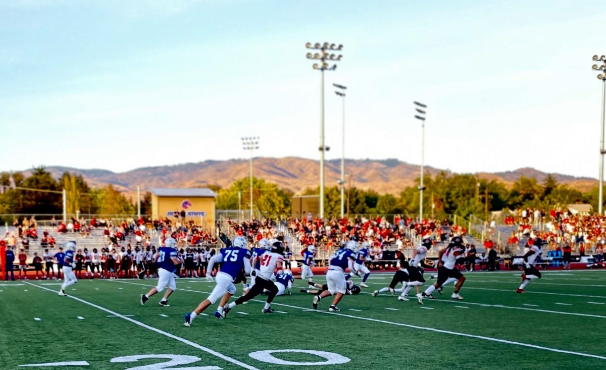 Varsity Football Offense Running Down the Field After Big Play