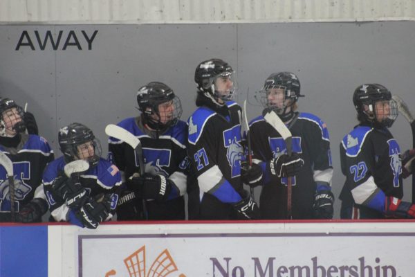 Timberline hockey watching the game from the bench.