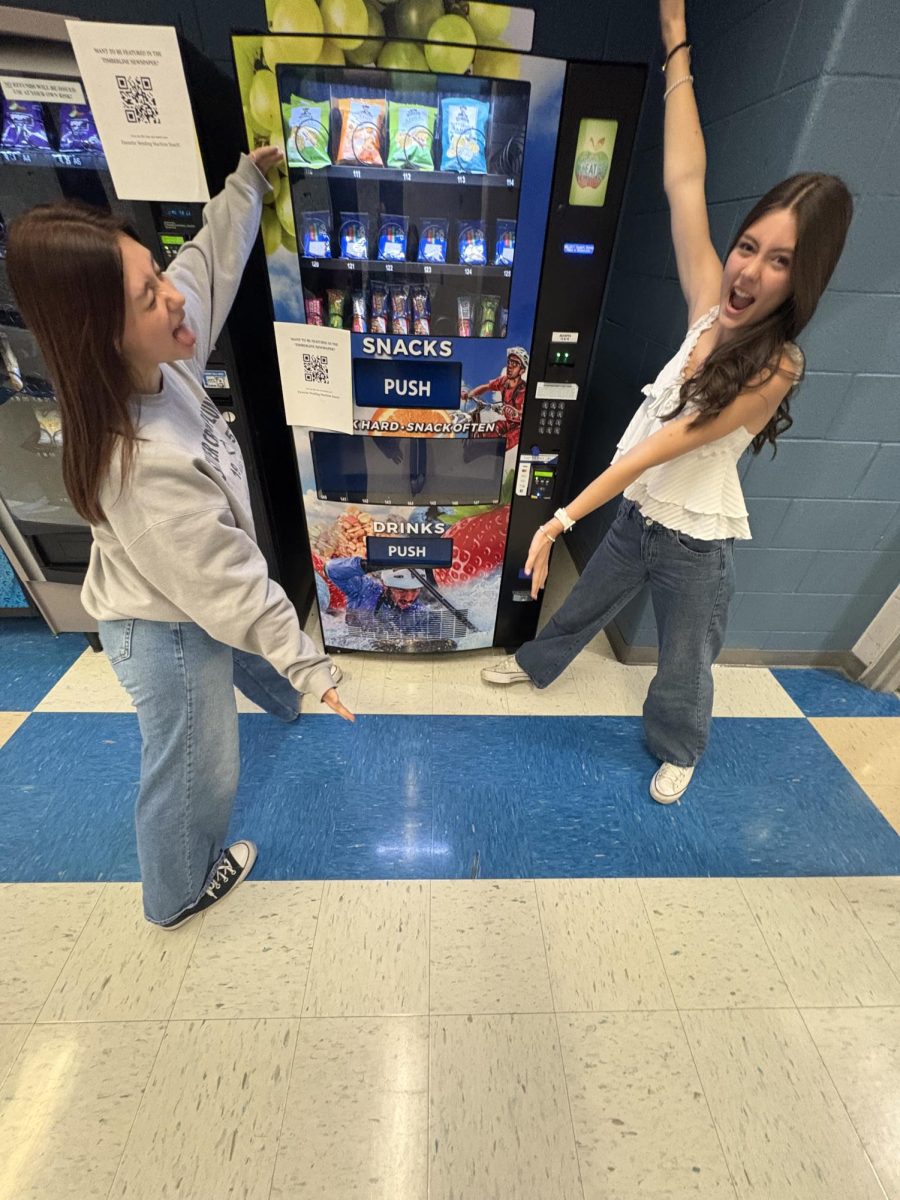 Our Newspaper Staff, Jessica LucasLundquist and Claire Hansen  showing the wide variety of vending machine snacks.