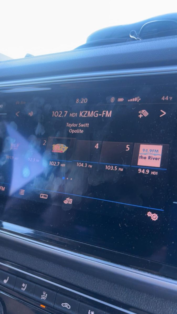 A picture of Taylor Swifts new song playing on the radio