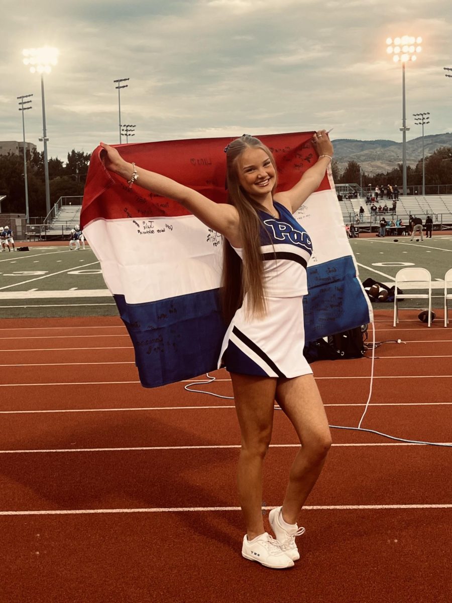 Lola Fledderus (Jr.) posing with her flag.