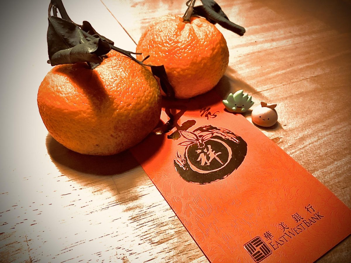 Oranges and a red envelope representative of good luck and fortune.